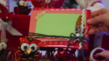 Opole, Poland - Feb 16 2017: Splendid Christmas Slide Show Cards, Photo Frames, Owls Made of Pine Cones, Red Santa and Other Hand Made Toys For Kids, Impress With Their Originality, While Lying Under a Decorated Fir Tree, With a Lot of Hand Made