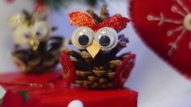 Opole, Poland - Feb 17 2017: Amazing Hand Made Owl and a Red Heart Are Placed Among Red Santa and Other Hand Made Toys For Kids, Lying Under a Decorated Fir Tree, With a Lot of Hand Made Toys,on a Violet Floor, Serving as a Nice Background