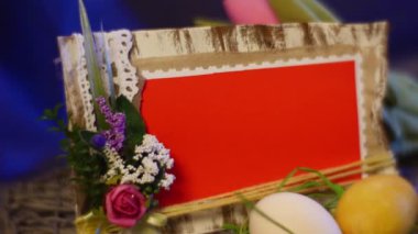 Opole, Poland - Jan 20 2017: Gorgeous Table Setting is Made of Easter Hen and Quail Eggs, a Festive Photo Frame, a Nice Bottle With a Candle, a Yellow Ring, a Set of Slide Cards, a Top Egg Cage