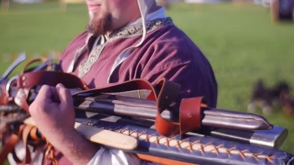 Man Carry Bunch of Tournament Swords in His Hands — Stock Video