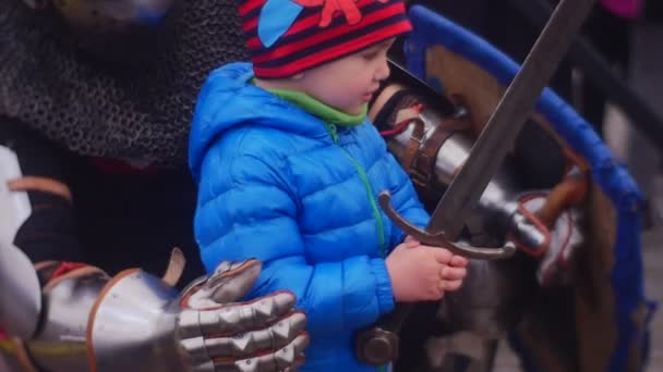 Το μικρό αγόρι κρατάει ένα βαρύ ξίφος — Αρχείο Βίντεο