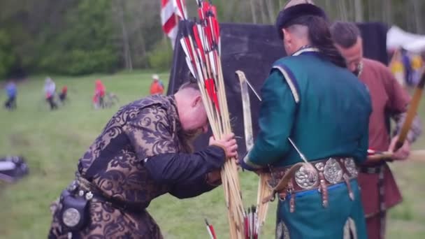 Squire förde ett dussin pilar till en bågskyttar medeltida Festival för bågskytte medeltida dräkter och tillbehör broderade kläder lägret av gamla krigare — Stockvideo