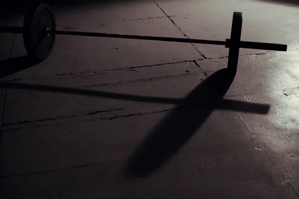 Barbell backlight and shadow in gym