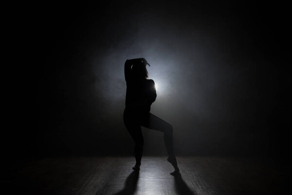 Silhouette of a dancer girl on a black background
