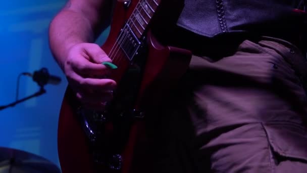 The musician plays solo on acoustic electro bass guitar at a rock concert — Stock Video