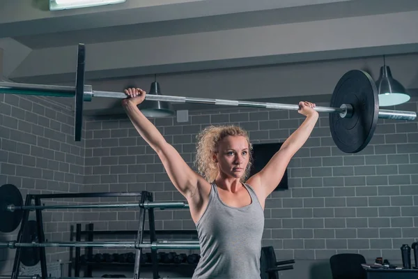 Deporte muscular chica plantea Barbell en CrossFit en el gimnasio — Foto de Stock