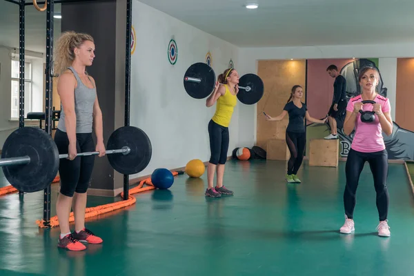Un grupo de personas realiza actividad física. Ejercicios de fuerza en el gimnasio — Foto de Stock
