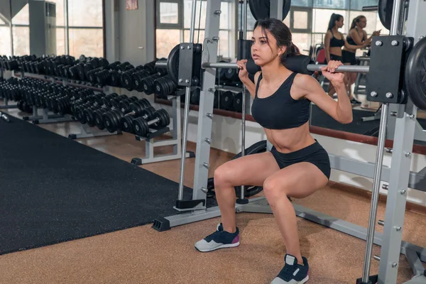 Health. Beauty. Sport. Girl lifting weights in the gym