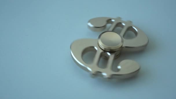 A golden spinner shaped like a dollar spins on a table. 4k resolution — Stock Video