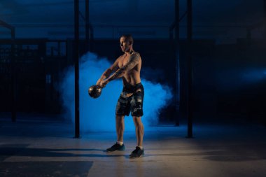 Atletizm sporcu adam ağırlık çeker. Halter