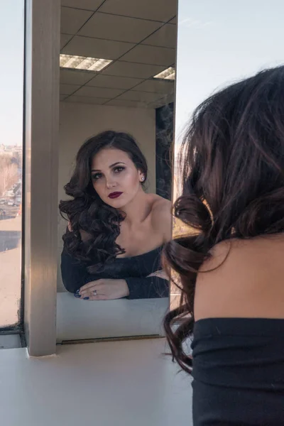 Encantadora chica hermosa admirándose en el espejo —  Fotos de Stock