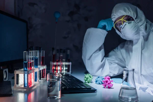 Scientists in white protective overalls is thinking what to do with coronaviruses. Stock Image