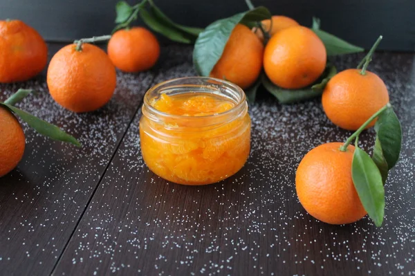 Tangerine jam in a glass jar.A traditional dessert at Christmas and New Year . — стоковое фото