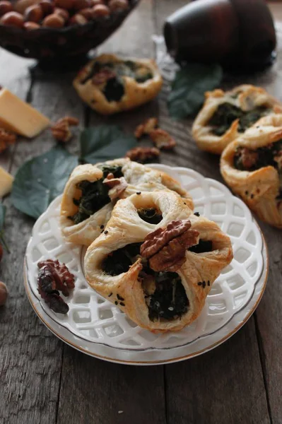 Spinach puffs with addition of cheese, walnuts and sesame seeds.Rustic style.