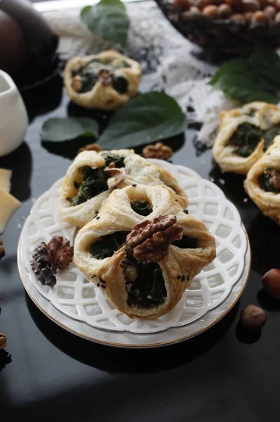 Spinach puffs with addition of cheese, walnuts and sesame seeds.Rustic style.