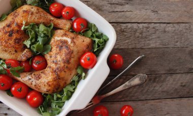 Baked chicken quarter with cherry tomatoes. Roast chicken quarter with the addition of cherry tomatoes. Selective focus clipart