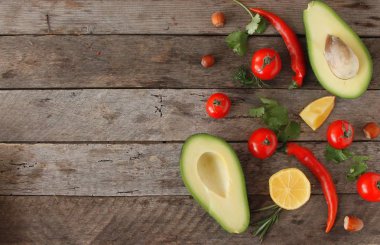 Avokado malzemeler ve baharat avokado Yapıştır veya guacamole. Avokado, maydanoz, biber biber, domates bir odun Background.Food veya sağlıklı beslenme kavramı. Vejetaryen. seçici odak.