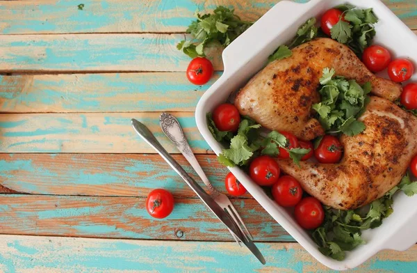 Baked chicken quarter with cherry tomatoes. Roast chicken quarter with the addition of cherry tomatoes. Selective focus