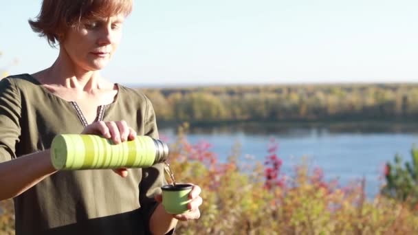 Человек наливает чай из термоса — стоковое видео