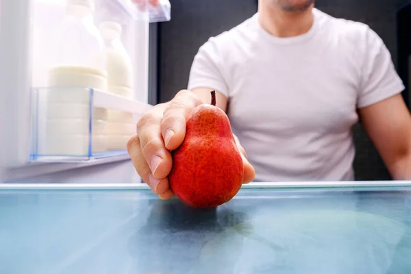 Man White Shirt Takes Red Pear Out Refrigerator Look — Stock Photo, Image