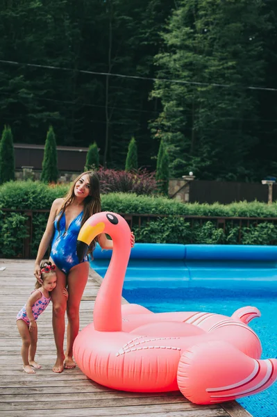Mother and daughter near pool — Stock Photo, Image