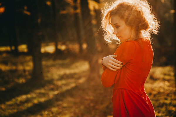 Beautiful redhead young woman in autumn forest