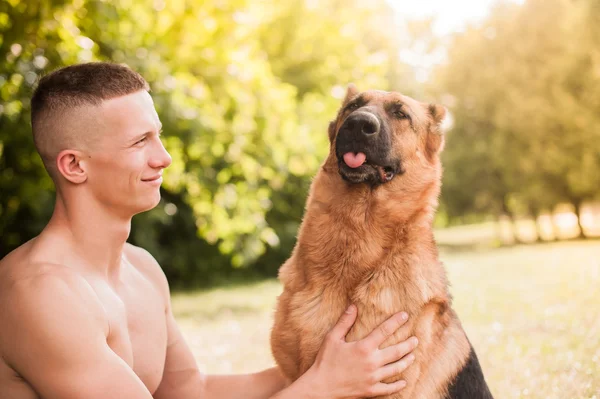 Athletic man and dog — Stock Photo, Image