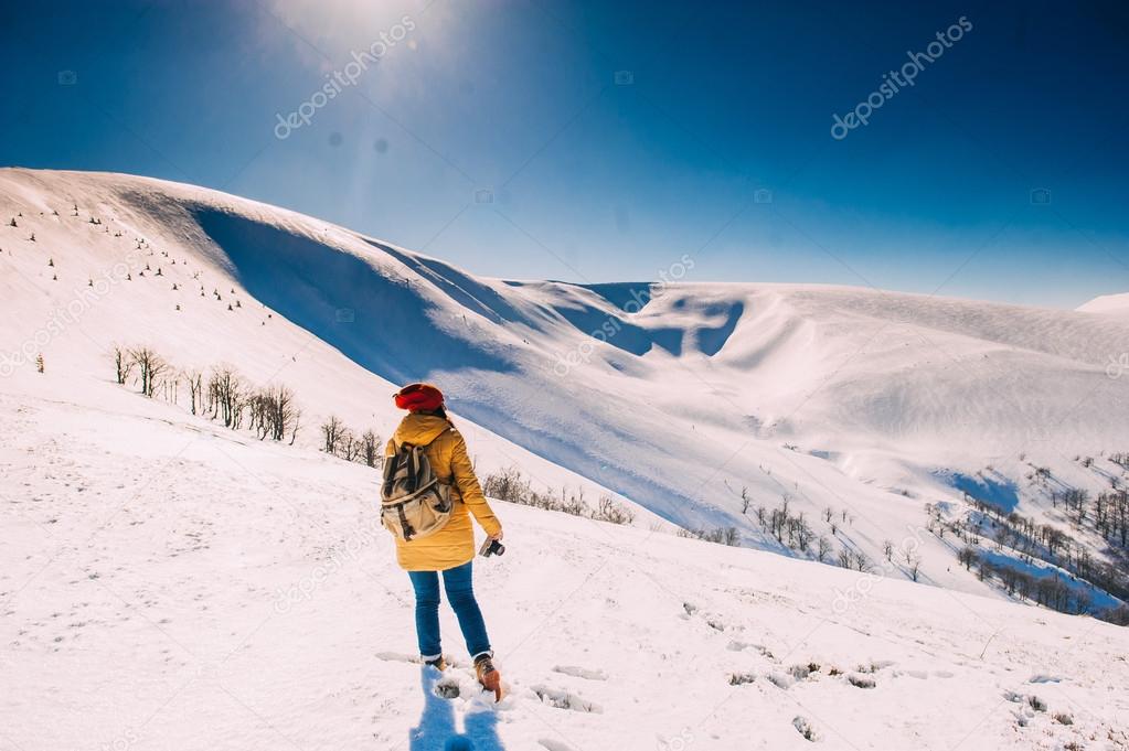 young woman in snowy mountains