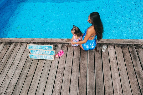 Madre e hija cerca de la piscina —  Fotos de Stock