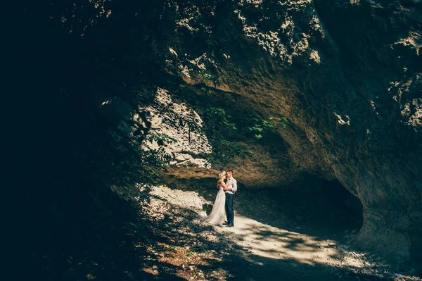 Pareja de boda cerca de rock — Foto de Stock