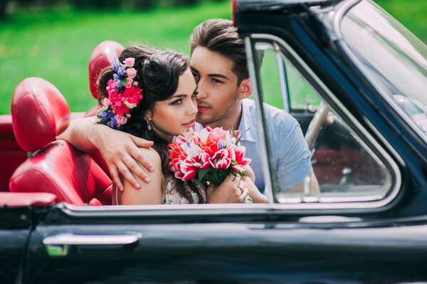 Young couple in vintage car