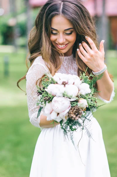 Красивая невеста с букетом в парке — стоковое фото