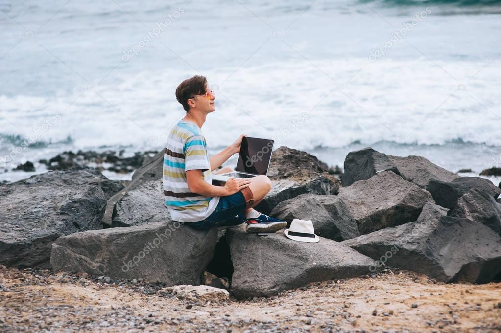 Business man working on the beach 