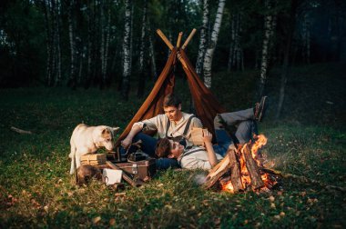 bir kamp ateşi etrafında oturan ikiz kardeşler 