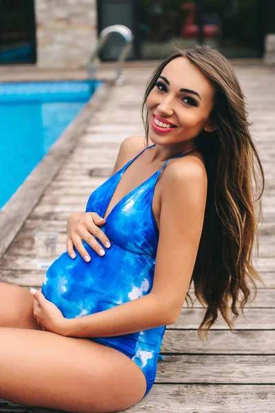 Gravid kvinne i badedrakt – stockfoto