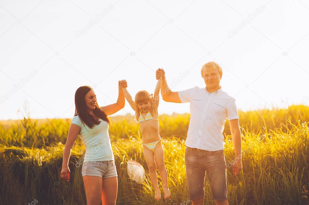 dad, mom and daughter  outdoor 