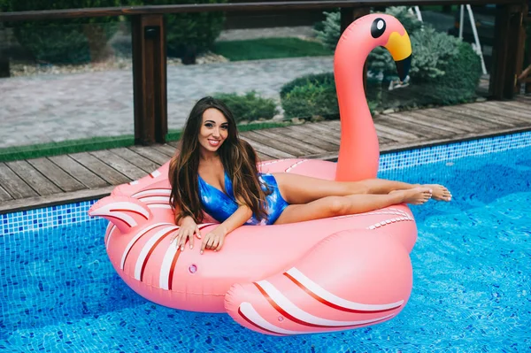 Woman in flamingo air mattress
