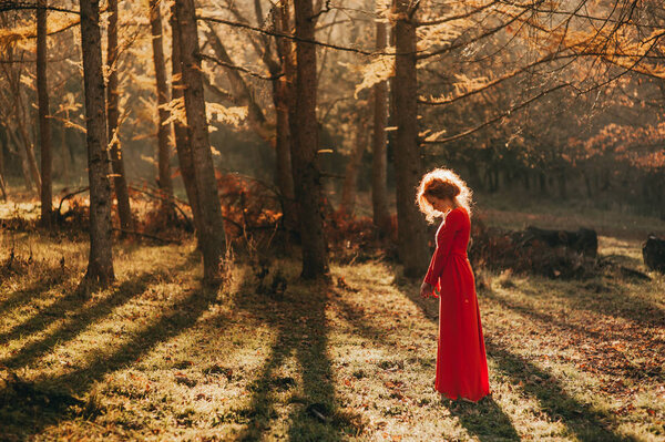 Fantastic redhead girl in a mysterious forest