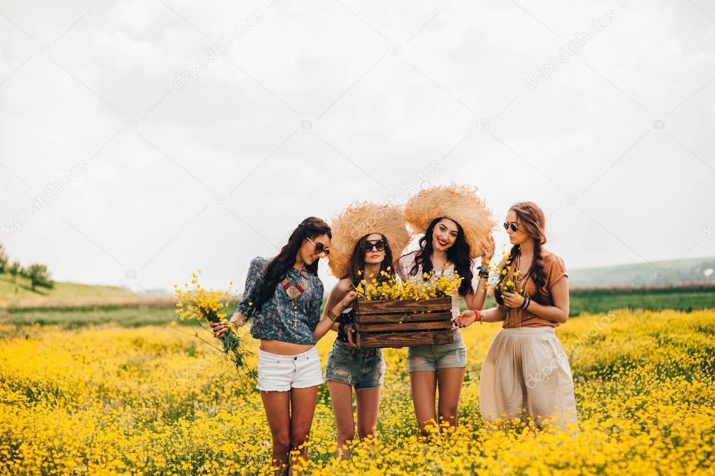 girls in a field of yellow flowers