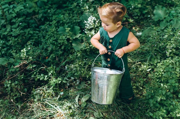Cute Little Boy Plays Bucket Grass — Stock Photo, Image