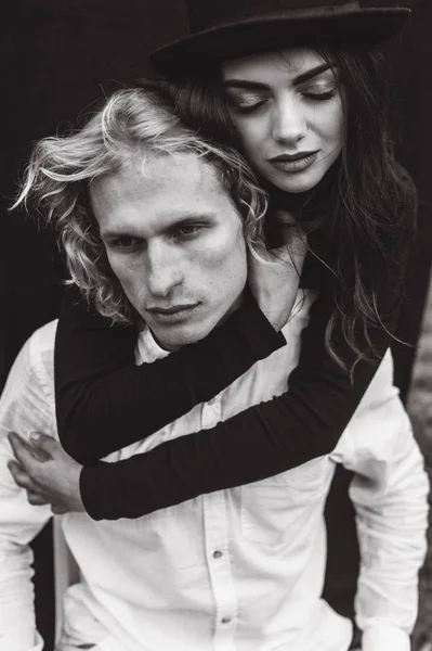 beautiful young  couple on a black background is full of emotions