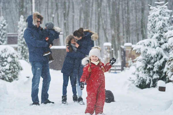 Happy family have a fun outside near the house in winter — Stock Photo, Image