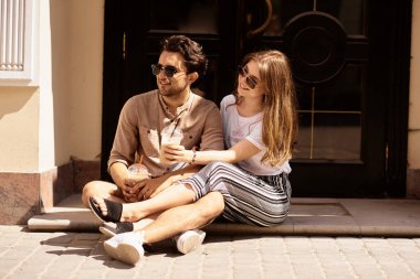 Genç ve güzel bir çift eğleniyor, sokaklarda yürüyor ve kahve içiyor.