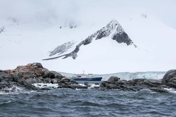 Paisaje marino dramático en la Antártida, barco contra fondo azul iceberg —  Fotos de Stock