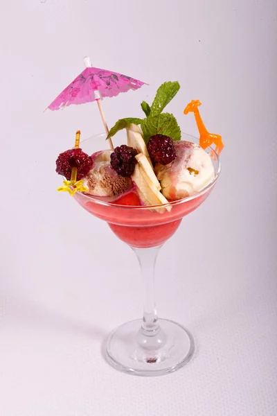 Dessert of ice cream, mint, fresh fruit in glass bowl