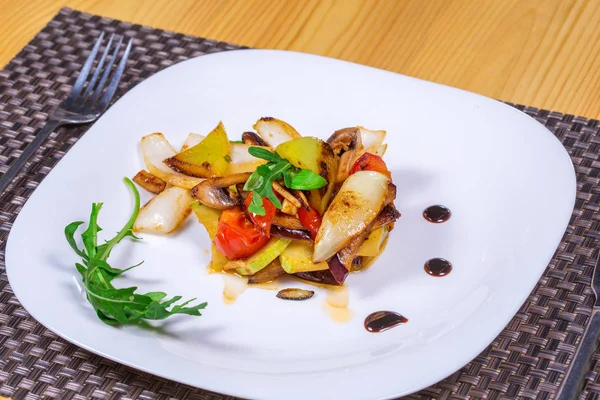 Salad of grilled vegetables on a white plate decorated herbs — Stock Photo, Image