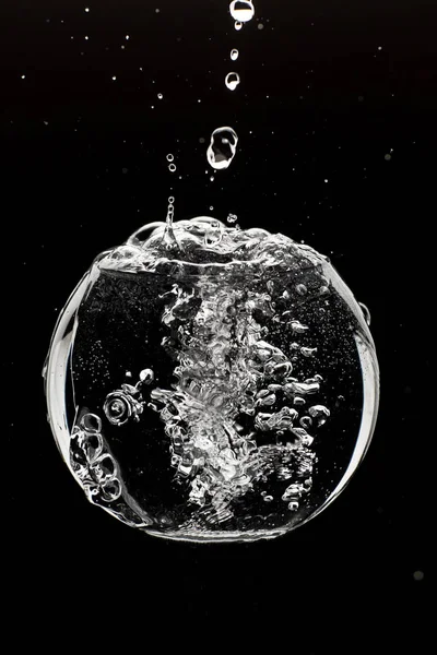 water splashing from glass isolated on black background.