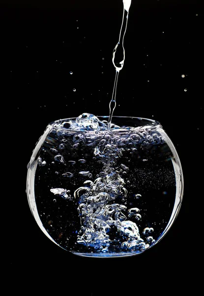 water splashing from glass isolated on black background.