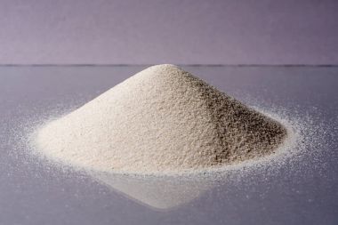 Pile of White Sand Isolated on violet Background. clipart