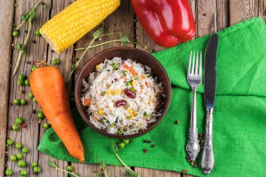 Tahtada sebzeli bir tabak pirinç.